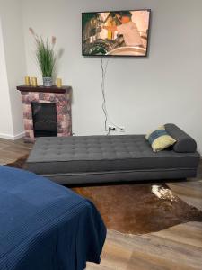 a bed sitting in a room with a fireplace at Ferienwohnung Nr 1 in Wunstorf +9 photos