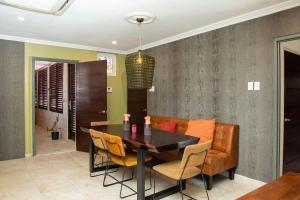 a dining room with a table and chairs at Executive apartment - Oranjestad in Oranjestad