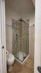 a bathroom with a toilet and a glass shower at Il Sogno del Lago in Anguillara Sabazia