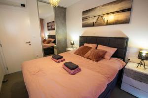 a bedroom with a large bed with two towels on it at Luxury Apartment Marija in Novalja