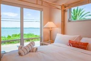 a bedroom with a bed with a view of the ocean at Haven House by Brightwild - Luxury Waterfront in Key West