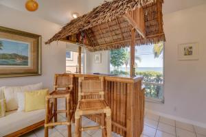 a living room with a bar with chairs and a couch at Haven House by Brightwild - Luxury Waterfront in Key West