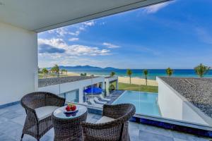 a villa with a view of the ocean at Golden Beachside Resort Danang in Da Nang