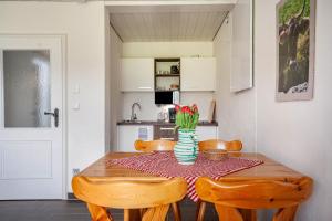 a dining room table with chairs and a vase of flowers at Appartement Braun 1 in Bolsterlang