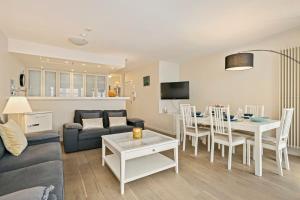 a living room with a couch and a dining room at Knokke La Douce - Cozy apartment with side sea-view at only 50 meters from beach in Knokke-Heist