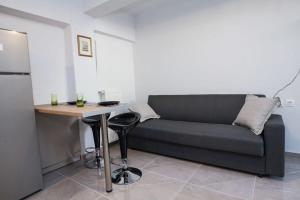 a living room with a couch and a small table at Charming Urban Oasis 1BR Apt near Megaro Mousikis in Athens