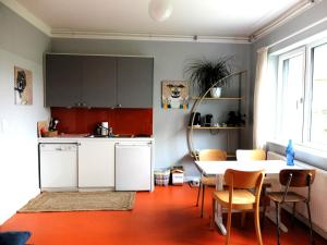 a kitchen with a table and a table and chairs at Cozy Place in Müllendorf