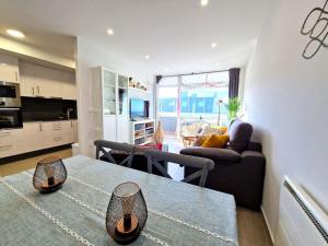 a kitchen and living room with a table and a couch at Dúplex playa Foz. Vistas al Mar, Terraza y Piscina in Foz