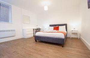 a white bedroom with a bed and a window at SAV Apartments Regent Leicester in Leicester