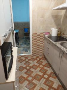 a bathroom with a sink and a shower with a tv at Casa araceli in Chipiona +7 photos