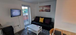 een woonkamer met een bank en een tafel bij SAV Apartments Nottingham Road Loughborough - 1 Bed Flat in Loughborough