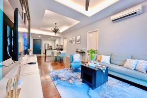 a living room with a couch and a tv at NEW! The Shore Residences 3BR Luxury I Direct access to Shopping I 6-10pax I 10minsJonker in Melaka