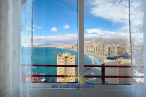 a window with a view of the ocean and a city at Doro Seaview Apartment in Benidorm