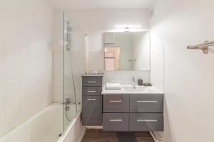a bathroom with a sink and a shower and a tub at Studio spacieux proche gare in Angers