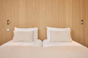 Postel nebo postele na pokoji v ubytování C-Hotels Silt