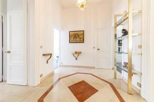 a large room with a hallway with white walls at Le Roi René appartement Haussmannien in Angers