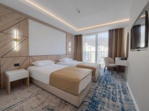 מיטה או מיטות בחדר ב-Hotel Tara Becici