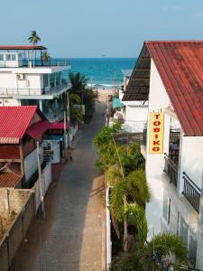 an empty street in front of the ocean at Hotel Tobiko in Trincomalee