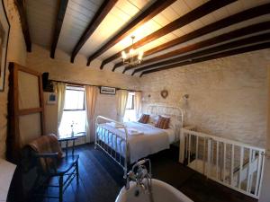 a bedroom with a bed and a tub in a room at Bryn-y-Gof in Llwyn-Dafydd