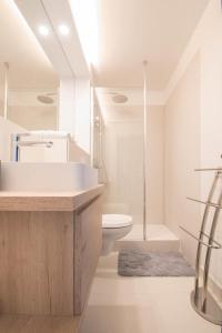 a bathroom with a sink and a toilet and a shower at LE DESIGN - Appartement vers la gare in La Baule