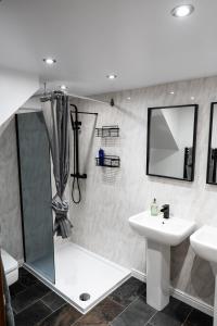 a bathroom with a sink and a shower and a toilet at Silverwood Loft in Telford