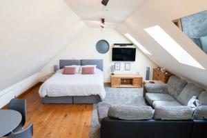 a bedroom with a bed and a couch at Silverwood Loft in Telford