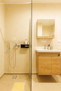a bathroom with a shower and a sink at Snug studio apartment with shared garden IV in Athens