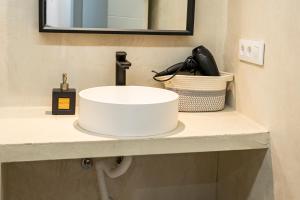 a white sink on a counter in a bathroom at Resolana Suites in Seville