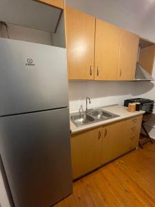 a kitchen with a stainless steel refrigerator and a sink at ΠΟΛΥΞΕΝΗ -ΕΚΑΒΗ in Kondiás +18 photos
