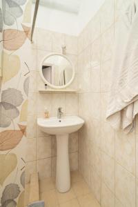 a bathroom with a sink and a mirror at Blue Houses Maisonettes in Kamária +61 photos