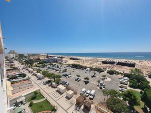 an aerial view of a parking lot next to the ocean at Vista Oceânica Paradise in Monte Gordo