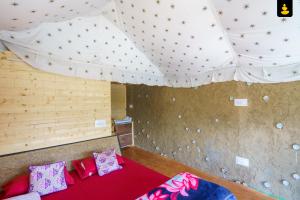 a room with a bed and a ceiling with stars at The Monk Campsite by Livingstone in Kalpa