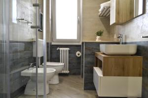 a bathroom with a sink and a toilet in it at Green and Blue Apartment in Rome +52 photos