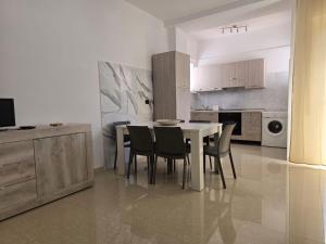 a kitchen with a table and chairs in a room at Poesia di Lerici in Lerici