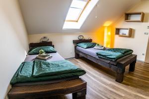 two twin beds in a room with a skylight at Penzion Víno Hruška in Veselí nad Moravou