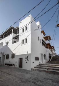a white building with stairs in front of it at K Town Suites Naxos in Naxos Chora