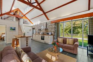 a living room with a couch and a table at Penpedwast Upper Barn Eglwyswrw in Eglwyswrw