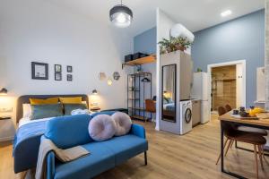 una camera da letto con divano blu e un soggiorno di Travel Habitat Patraix Suite con Terracita a Valencia