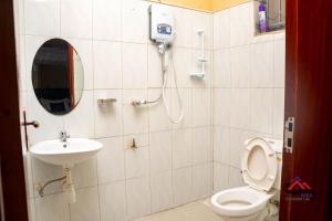 a bathroom with a toilet and a sink at Kica Apartment with Airconditioned bedrooms in Lira, Uganda in Lira