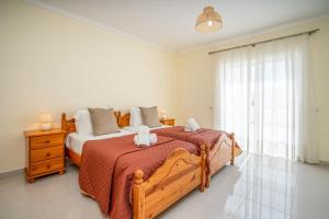 a bedroom with a large bed and a window at Casa da Amoreira in Alvor +40 photos