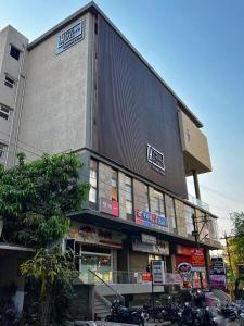 a large building with motorcycles parked in front of it at The Living Hub Hotel, Kolhapur- Walkable From Central Bus Station in Kolhapur