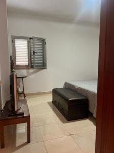 a bedroom with a bed and a tv and a table at Apartamento Bonito Las Canteras in Las Palmas de Gran Canaria