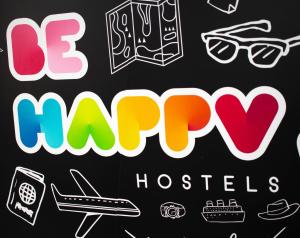 un grupo de pegatinas en una pizarra con diferentes tipos de objetos en Be Happy Hostel, en Nerja