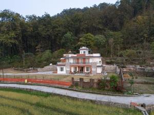 a large house on the side of a hill at The Chirpy Bungalow By LUHO Leisure in Dehradun