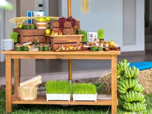 a table with plants and fruits and vegetables on it at Grand Mercure Phuket Patong in Patong Beach