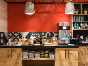 a restaurant with a counter with food on it at ibis Styles Lille Centre Grand Place in Lille