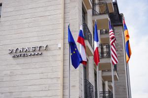 un groupe de drapeaux sur le côté d'un bâtiment dans l'établissement Hotel Dynasty, à Erevan