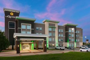 a rendering of a hotel with a parking lot at La Quinta Inn & Suites by Wyndham Ft Worth-Burleson in Burleson