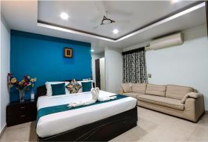 a bedroom with a large bed and a couch at Fortune pent House Villa in Hyderabad