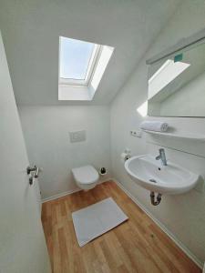 Un baño con lavabo, inodoro y ventana. en Apartments EFDE GmbH, en Heilbronn 208 fotos más